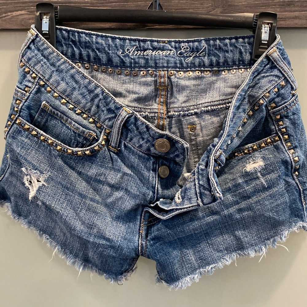 American Eagle medium wash studded cutoff shorts